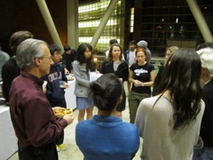 Students interact with Dr. Wayne at reception.
